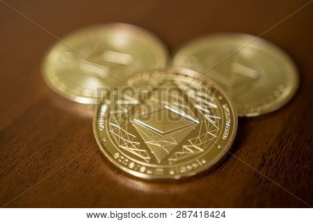 Golden Etherium Coin Close Up. Ether Is A Cryptocurrency Whose Blockchain Is Generated By The Ethere