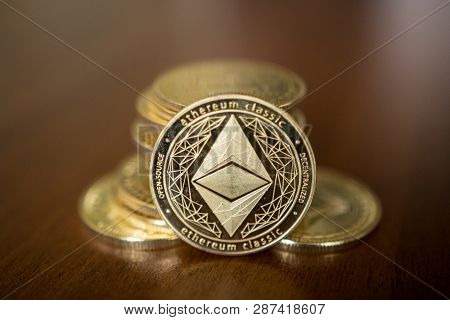 Golden Etherium Coin Close Up. Ether Is A Cryptocurrency Whose Blockchain Is Generated By The Ethere