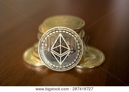 Golden Etherium Coin Close Up. Ether Is A Cryptocurrency Whose Blockchain Is Generated By The Ethere