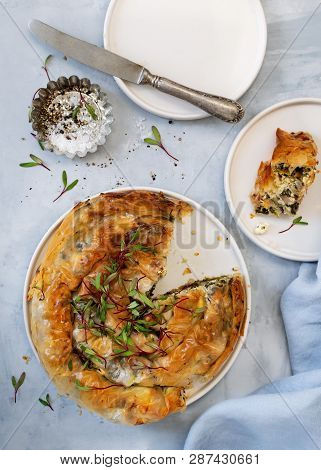 Greek Pie Spanakopita On Light Blue Background. Ideas And Recipes For Vegetarian Or Vegan Spinach Pi