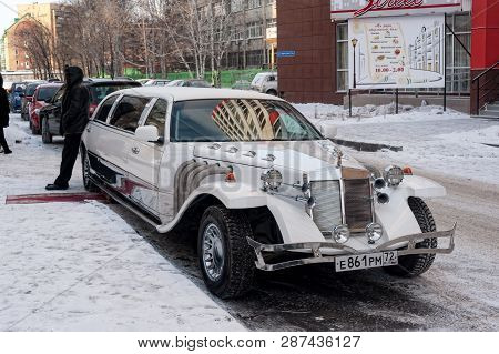 Tyumen, Russia - January 29, 2012: Vintage Wedding Car Decorated With Flowers Stands Near The Perina