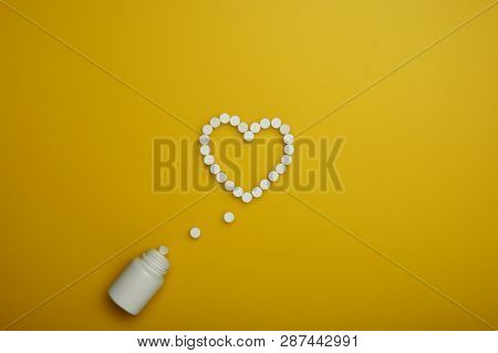 Creative Healthcare And Medicine Concept Photo Of Heart Made Of Drugs And Pills On Yellow Background