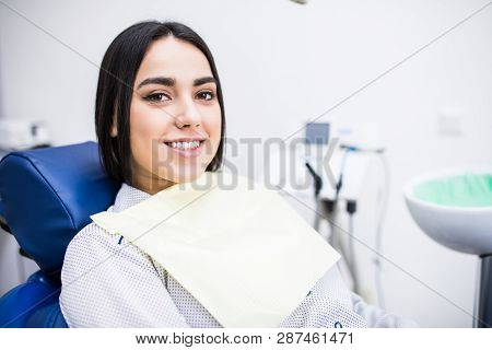 Overview Of Dental Caries Prevention. Woman At The Dentist's Chair During A Dental Procedure. Beauti