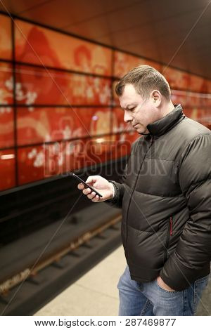 Man With Smartphone On Platform