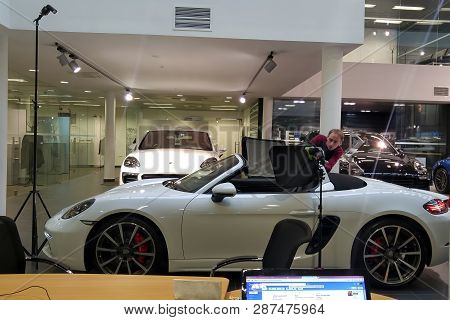 Moscow. February 2019. A Photographer Take Photographs The Interior Of A Porsche 718 In The Showroom