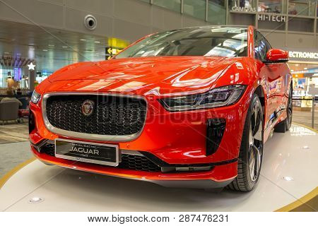 Singapore. March 2019. Orange Jaguar I-pace All Electric Suv. Front View. Standed In Airport. Cars O