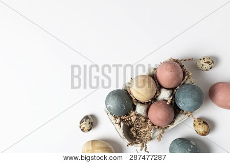Selective Focus Of Coloured Decorated Easter Eggs In Cardboard Container, Minimal On White