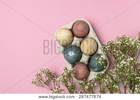Selective Focus Of Coloured Decorated Easter Eggs In Cardboard Container, Gypsophila Flowers