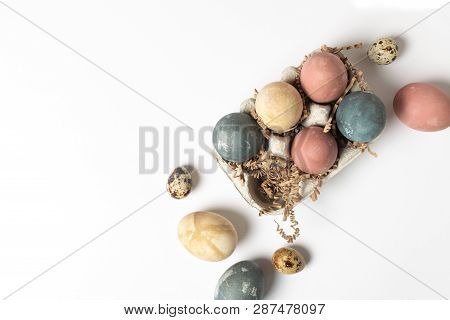 Selective Focus Of Coloured Decorated Easter Eggs In Cardboard Container, Minimal On White