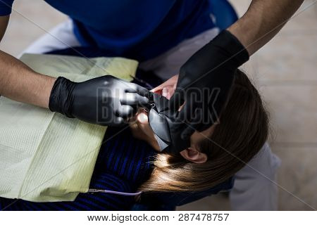 Modern Dental Equipment. Dentist Treats Tooth Decay In The Teeth With A Dental Drill, Saliva Ejector