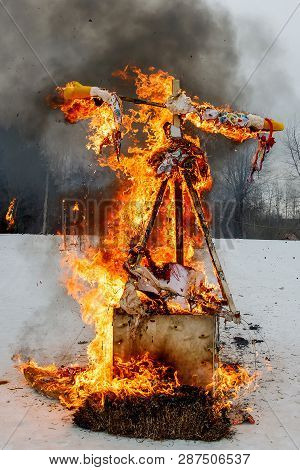 Spring Meeting. Close-up Faceless Straw Effigy Of Dummy Of Maslenitsa, Symbol Of Winter And Death In