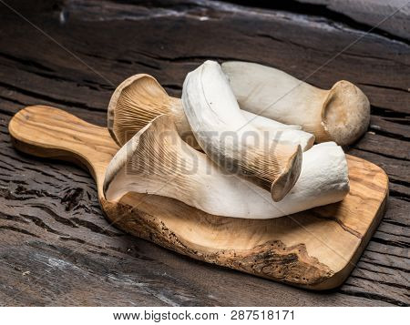 King oyster mushrooms on the wooden background.
