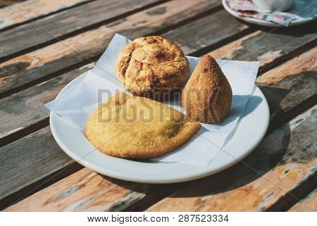 Traditional Portuguese And Brazilian Snacks On A Plate: Coxinha, Empada De Galinha, And Rissole
