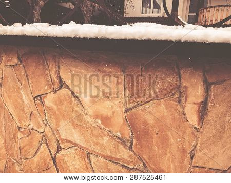 Srone Gate With Decorative Steel Trim. Snowfall On The Street.noon.