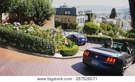 San Francisco, California, Usa - August 30, 2015: Shot Of A Luxury Car Driving Down Lombard Street I