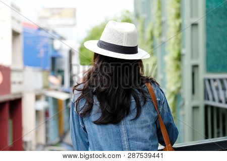 Back Side Of  Woman Traveler Standing With City Outdoors Background, Casual Lifesyle, Travel Blogger