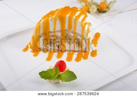White Spoonge Peice Of Cake With Yellow Syrup