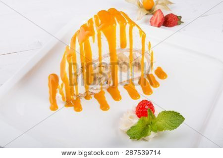 White Spoonge Peice Of Cake With Yellow Syrup
