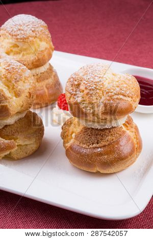 Baked French Desserts Suffed With Cream And Served With Jam