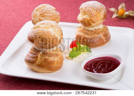 Baked French Desserts Suffed With Cream And Served With Jam