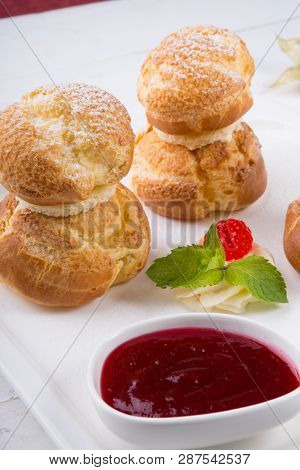 Baked French Desserts Suffed With Cream And Served With Jam
