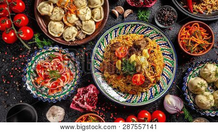Traditional Uzbek Oriental Cuisine. Uzbek Family Table From Different Dishes In National Dishes For