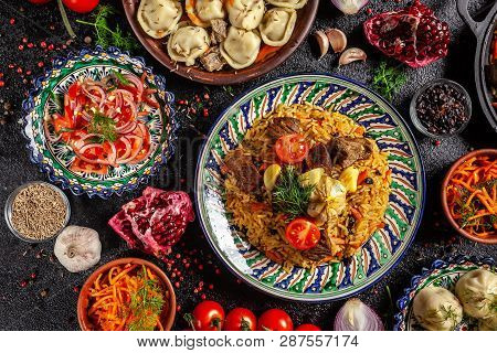 Traditional Uzbek Oriental Cuisine. Uzbek Family Table From Different Dishes In National Dishes For