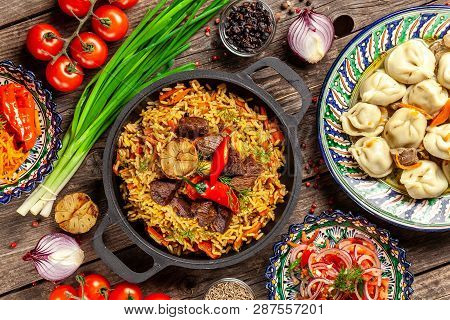 Traditional Uzbek Oriental Cuisine. Uzbek Family Table From Different Dishes In National Dishes For