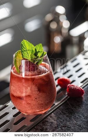 Cocktail Drink Frozen Raspberries  Daiquiri At Barcounter In Night Club Or Restaurant.
