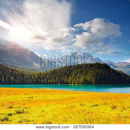 Exotic alpine lake Champfer in beautiful summer day. Location place Silvaplana village, Swiss alps, district Maloja, Europe. Scenic image of popular tourist destination. Discover the beauty of earth.