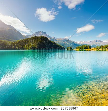 Exotic alpine lake Champfer in beautiful summer day. Location place Silvaplana village, Swiss alps, district Maloja, Europe. Scenic image of popular tourist destination. Discover the beauty of earth.