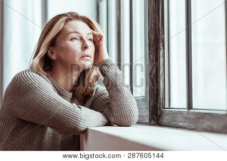 Beautiful Mature Woman Feeling Stressed Looking Into Window