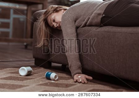 Blonde-haired Woman Falling Asleep After Taking Too Many Pills