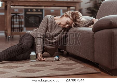 Blonde Woman Falling On Floor After Taking Too Many Meds