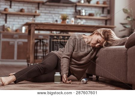 Woman Falling On Floor Near Sofa After Medication Poisoning