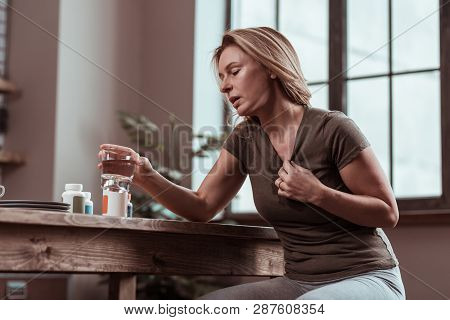 Blonde Woman Suffering From Panic Attacks Taking Pills