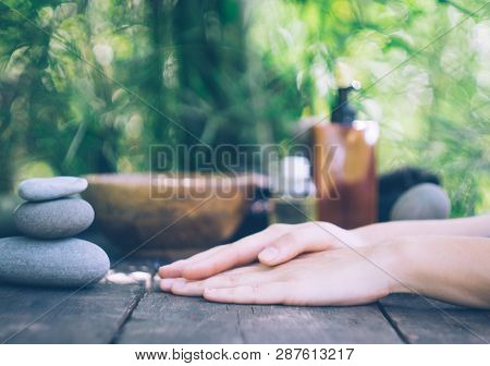 Spa Background With Woman's Hands And Clear Water On An Old Wooden Table. Japanese Style. Simplicity