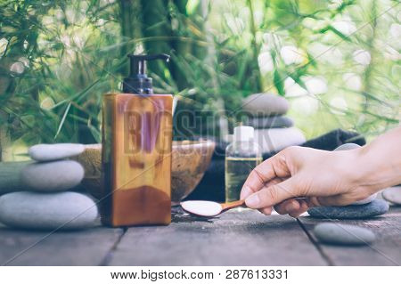 Spa Background With Woman's Hands And Clear Water On An Old Wooden Table. Japanese Style. Simplicity
