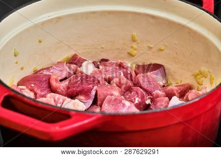Preparing Perkelt Sauce - Cooking Meat And Onion In Red Pot