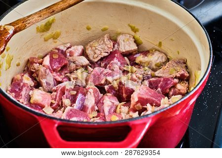 Preparing Perkelt Sauce - Cooking Meat And Onion In Red Pot