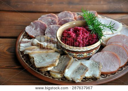 A Bowl Of Grated Horseradish With Beetroot, Served With Assortment Of Lard And Sausages - Typical Uk