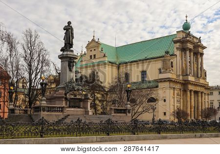 Warsaw, Poland - February 27 2019: Adam Mickiewicz Monument And Church Of Saint Joseph At The Center