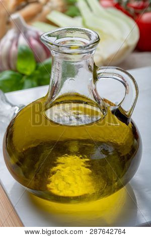 Virgin Natural Olive Oil Is Glass Bottle, Served With Traditional Mediterranean Food