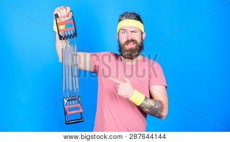 Man Bearded Athlete Exercising With Expander. Guide Use Expander Proper Way. Try Stretching Exercise