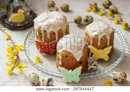 Easter Composition Of Easter Cakes, Biscuits, Eggs And Forsythia Flowers. Rustic Style.