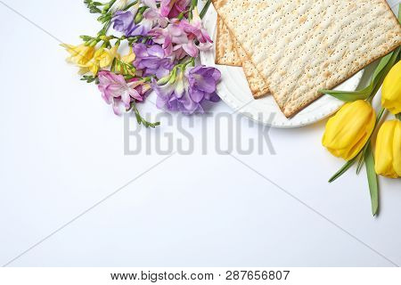 Composition With Matzo And Flowers On White Background, Top View. Passover (pesach) Seder