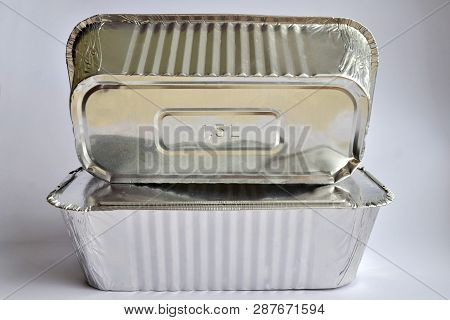 Two Disposable Foil Containers For Take-away Food On A White Background. One Of Them With The Inscri