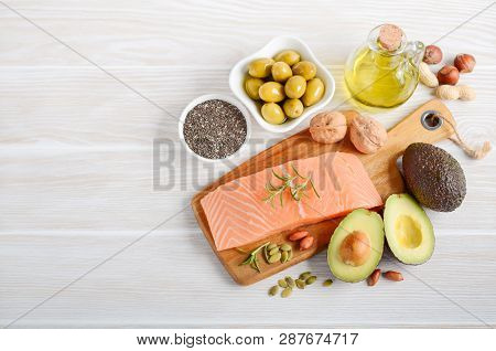 Selection Of Healthy Unsaturated Fats, Omega 3 - Fish, Avocado, Olives, Nuts And Seeds.