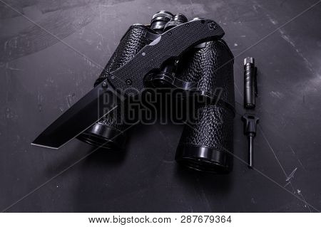 Big Black Knife. Knife And Binoculars. Outdoor Accessories.