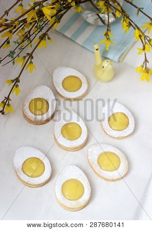 Homemade Easter Lemon Cookies And Forsythia Blooming Twigs On A Light Background.